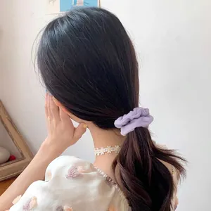 4-piece set of lilac oversized scrunchies in soft velvet fabric shown on a ponytail