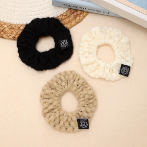 3-pack knit scrunchies in black, beige, and khaki with a rose logo patch