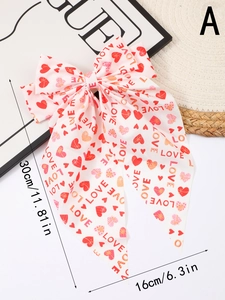 Pink chiffon hair bow with red heart prints and LOVE text on white background