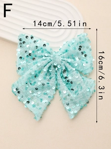 Detail view of mint green sequin bow hair clip with 14cm width and 16cm height dimensions