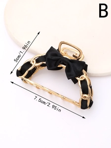 Detail view of gold chain hair claw clip with black silk bow and size measurements