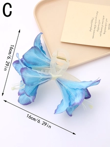 Detail view of large blue lily flower hair claw clip with 16cm size measurement