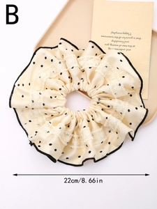 Detailansicht des 22cm großen Haargummis in Creme mit Punkten und dekorativer Spitze