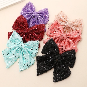 Large handmade sequin bow hair clips in purple, red, pink, and black colors