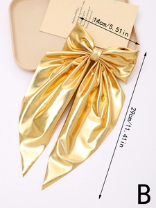 Detail showing dimensions of a large golden metallic bow clip with long ribbons