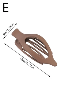 Detail view of a 12cm brown matte leopard hair claw clip with hollow oval design