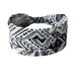 Close-up of black and white paisley print stretchy headband with twisted knot detail