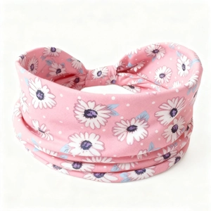 Detail of pink daisy print headband showing soft elastic cotton fabric and knot design