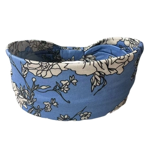 Close-up of wide elastic cotton headband with blue floral print for yoga and sports