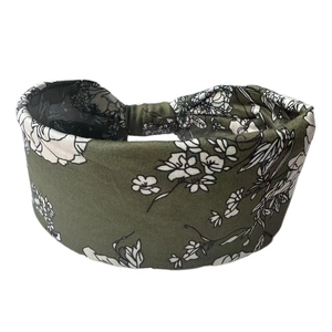 Detail view of olive green floral bohemian wide headband with elastic cotton fabric texture