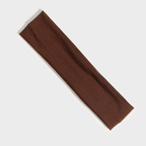 Close-up of brown elastic sports headband with soft knit texture for yoga and fitness