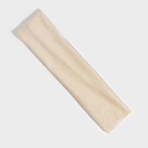 Close-up of cream elastic knitted sports headband texture for yoga and fitness training