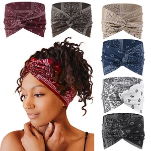 Detail view of seven bohemian paisley knot headbands in various colors for sports and yoga