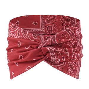 Detail of red paisley knotted headband featuring bohemian pattern and soft elastic fabric