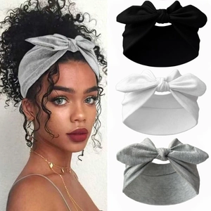Elastic knot bow headbands in black, white and grey colors shown on model and flat