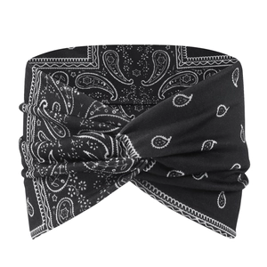 Close-up of black paisley printed sports headband with twisted knot design and soft texture