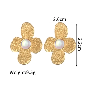 Detailed view of vintage gold flower earrings with hammer texture and measurements