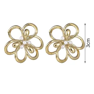 Detail showing vintage hollow flower stud earrings with pearl center and 3cm measurement