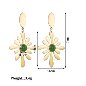 Close-up of 18K gold-plated flower earrings with green cat-eye stone and retro design