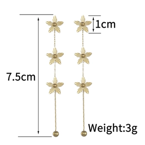 Macro detail of vintage 18K gold plated flower tassel earrings with 7.5cm length dimensions