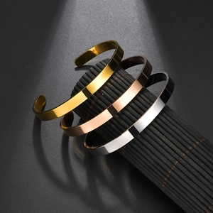 Three minimalist stainless steel open C-shaped bracelets in gold, silver, and rose gold