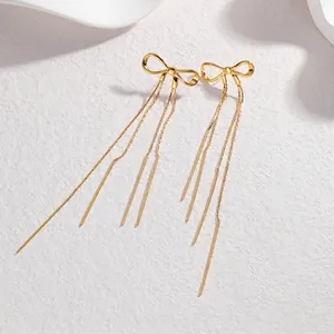 Elegant gold bow-shaped long tassel earrings with minimalist dangling metal chains
