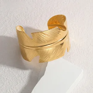 Detailed view of the intricate feather texture on this gold wide open cuff bracelet