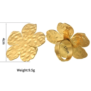 Detailed view of large gold floral napkin ring featuring a unique hammered metal texture