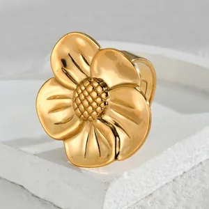 Irregular gold flower ring in stainless steel with detailed stamen on white stone