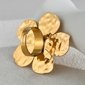 Elegant gold large flower open ring with hammered texture on white hand model