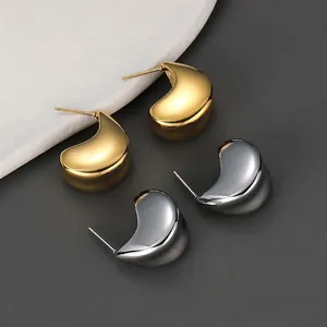 Minimalist C-shaped titanium steel stud earrings in polished gold and silver finishes
