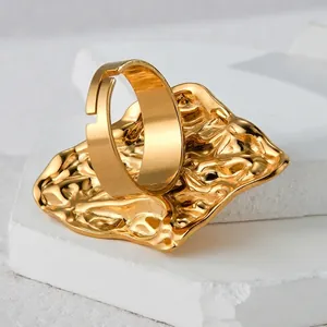 Artistic gold-plated stainless steel ring with irregular lava texture and open design