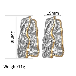 Detailed view of irregular pleated gold and silver earrings with 36mm height dimensions