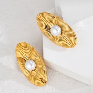 Exaggerated 18K gold plated oval textured stud earrings featuring a central white pearl