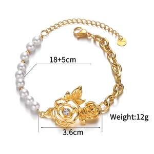 Dettaglio del bracciale in acciaio dorato con perle bianche e ciondolo a rosa
