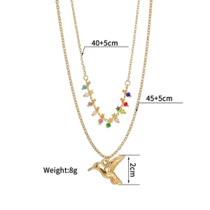 Detail of double-layer necklace with hummingbird pendant, colorful beads and star charm