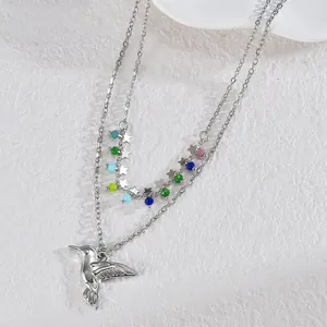 Detail view of double-layer necklace with colorful beads and a hummingbird pendant