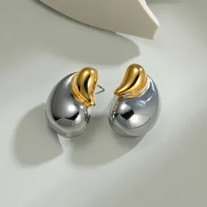 Detailed close-up of teardrop earrings with elegant gold and silver contrast plating
