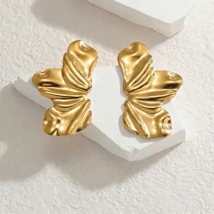 Boucles d'oreilles pétales dorées irrégulières avec texture organique sur pierre