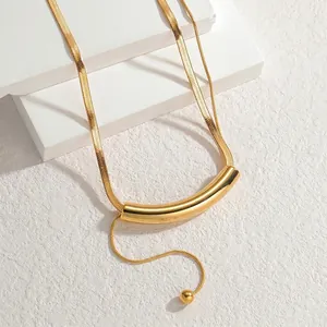 Elegant gold stainless steel snake chain necklace with a curved cylindrical pendant