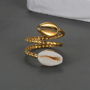 Detailed macro view of the spiral gold-tone ring with shell motifs and rope texture