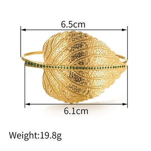 Detail of gold leaf bangle with green stones showing dimensions 6.5cm width and 6.1cm height