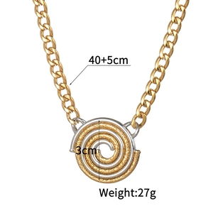 Macro shot of two-tone gold and silver vortex pendant with spiral texture and flat chain