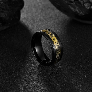 Steampunk black titanium steel ring with intricate gold gear mechanical aesthetic inlay