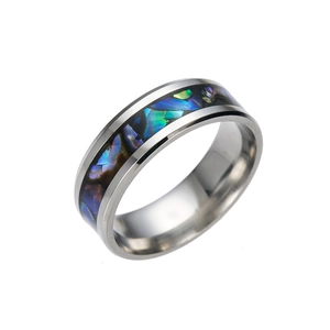 Polished stainless steel ring with iridescent abalone shell inlay from a side angle