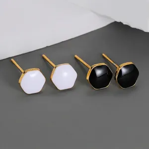 Geometric hexagon stud earrings set in black and white enamel with gold plated finish