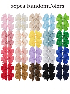 Flat lay of 58 colorful grosgrain ribbon hair bows for girls in various vibrant shades