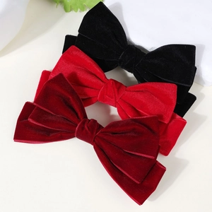 Three-piece velvet bow hair clip set in black, bright red, and deep burgundy colors