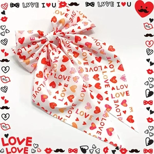 Detail shot of white ribbon hair clip with red heart prints and LOVE lettering