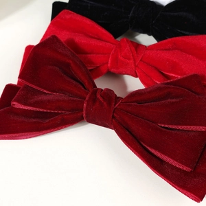 Detail of red and black velvet triple-layer bow hair clips with refined stitching